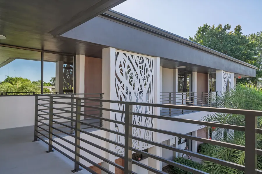 Second-floor balcony with decorative screen