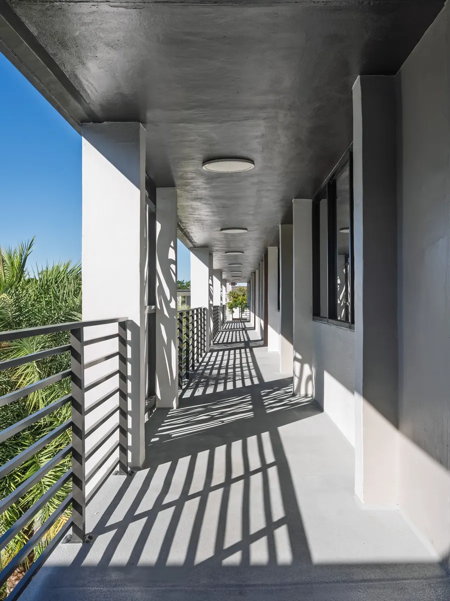Sunlit covered walkway lined with columns