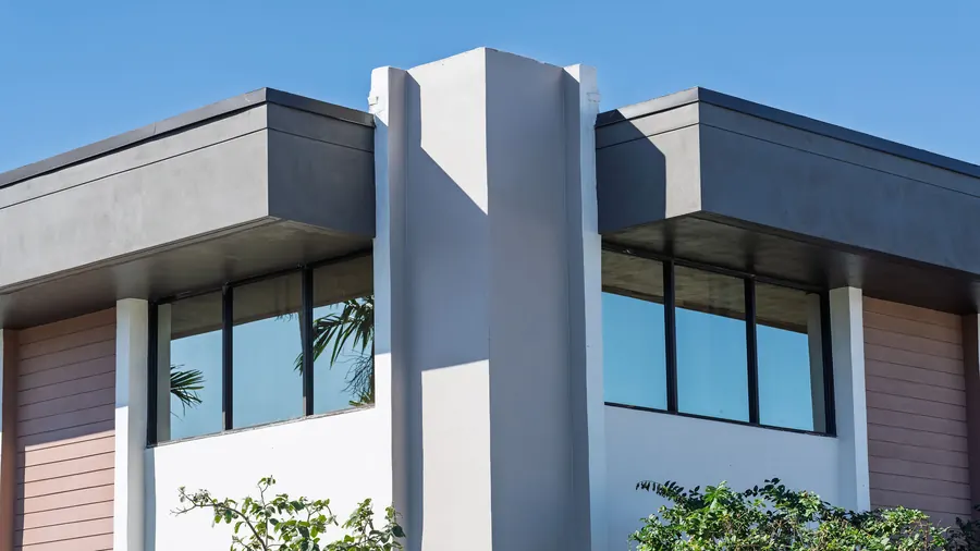 Modern rooflines against a blue sky